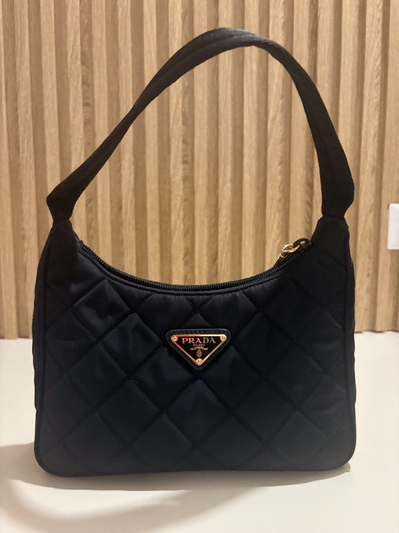 Prada Re- edition Tessuto Quilted Nylon Bag Black (Category: Luxury Bags & Wallets) located in Cainta. Submitted by jessicamaegalang (Listing ID 1459116471, Image 1). Description: - Authentic Black Prada Hobo Bag - Quilted Nylon Material - Elegant Gold Hardware Details - Secure Zipper Closure - Interior features Prada Milano logo lining - Ideal everyday bag, fits all your essentials.