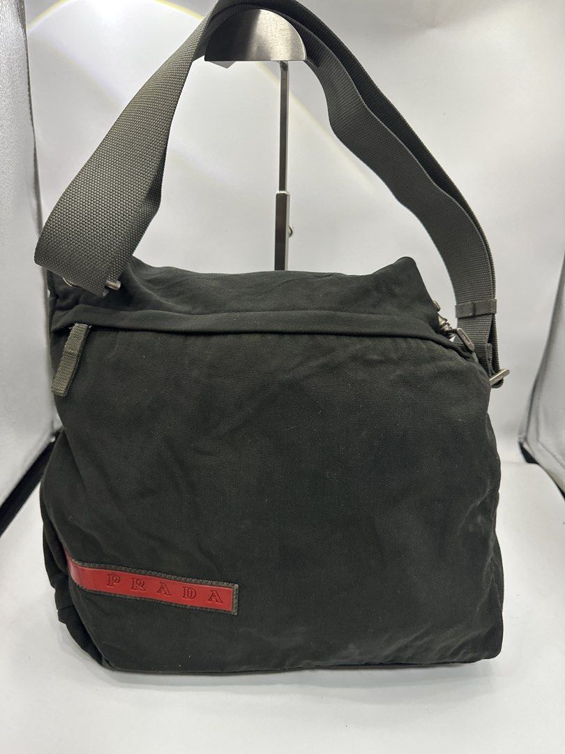 Prada Tessuto Shoulder Bag Dark Green (Category: Luxury Bags & Wallets) located in Baguio. Submitted by luxukayukay (Listing ID 1459242731, Image 1). Description: - Authentic Prada shoulder bag - Made in Italy - 100% Polyamide exterior - 100% Nylon lining - Red Prada logo tab - Adjustable strap - Interior zip pocket - Ideal for everyday use.