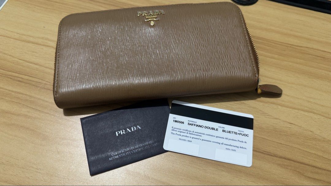 PRELOVED Prada Saffiano Double Zip Around Wallet (Category: Luxury Bags & Wallets) located in Quezon City. Submitted by mrsp_28 (Listing ID 1459100111, Image 2). Description: - Authentic Prada Wallet - Material: Saffiano Leather - Color: Brown - Closure: Zip-around - Includes: Authenticity Card MOP: BPI/GCASH/MARIBANK.