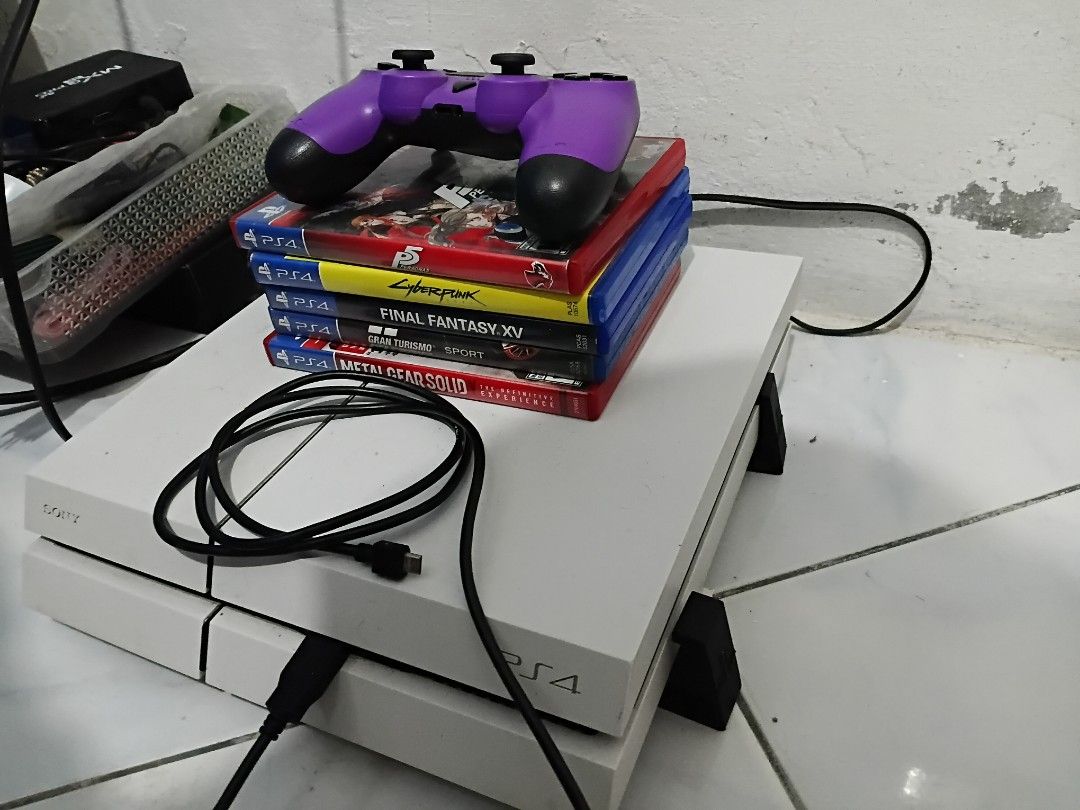 PS4 1TB PHAT BUNDLE (Category: PlayStation) located in Valenzuela. Submitted by rjr216 (Listing ID 1459169319, Image 1). Description: For sale/Swap Negotiable Lowballers will be ignored Details: - Phat version - Latest firmware, ready for online - 1tb storage - Good condition Inclusions: - Ps4 controller (fake) - Ps4 games (mgsv definitive edition, cyberpunk, persona 5, ffxv, gran turismo) - Ps4 stands - Charger - Power cable Perefered MOP and MO