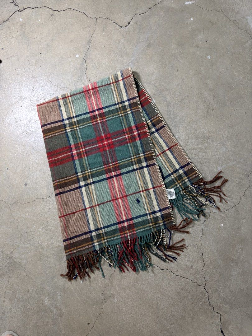 Ralph Lauren Home Plaid wool blanket (Category: Scarves) located in Alfonso. Submitted by jbcamet (Listing ID 1459211764, Image 1). Description: - Authentic Ralph Lauren Home plaid scarf - Made from 100% premium wool - Generous size: 75cm x 140cm - Elegant fringe trim detail - Iconic embroidered Ralph Lauren polo player logo - Adds warmth and sophisticated style to any outfit - Ideal for autumn and winter seasons.