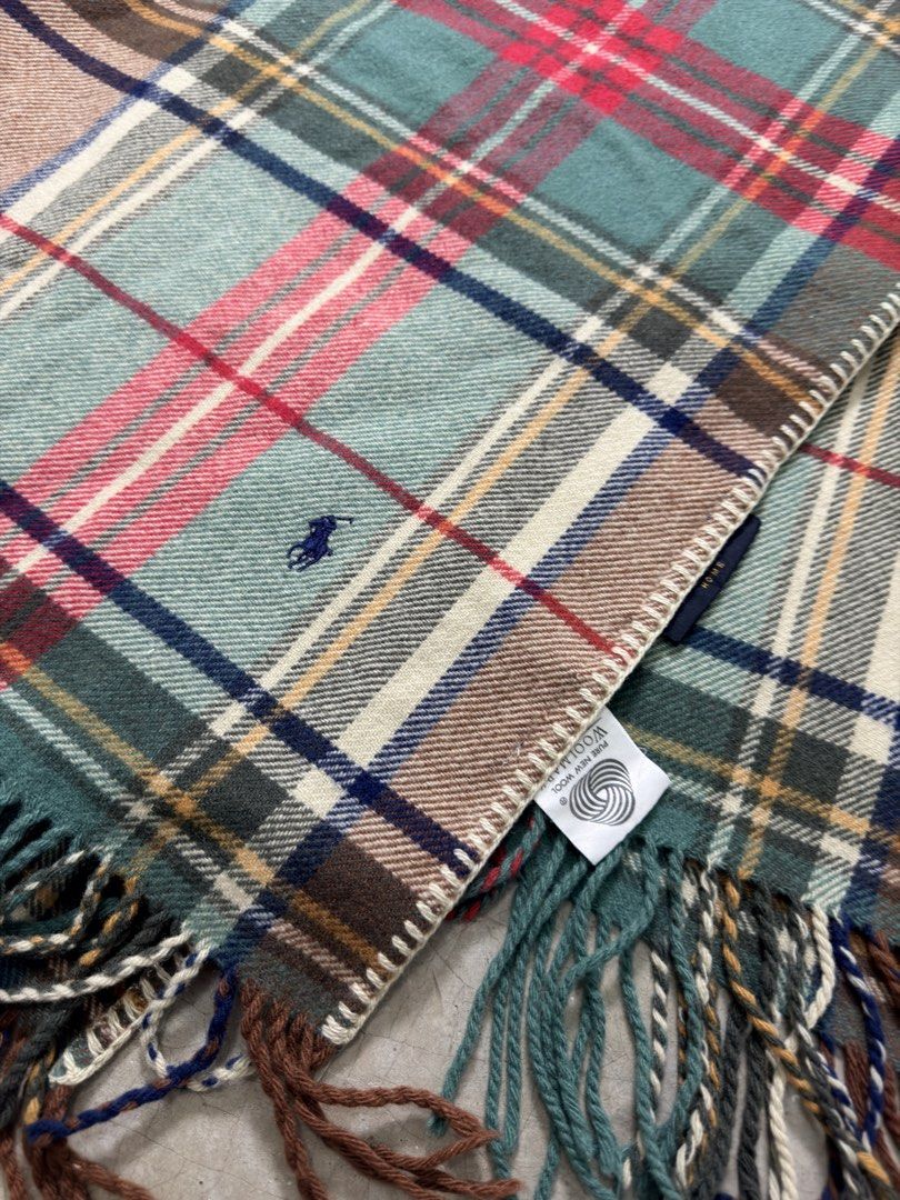 Ralph Lauren Home Plaid wool blanket (Category: Scarves) located in Alfonso. Submitted by jbcamet (Listing ID 1459211764, Image 2). Description: - Authentic Ralph Lauren Home plaid scarf - Made from 100% premium wool - Generous size: 75cm x 140cm - Elegant fringe trim detail - Iconic embroidered Ralph Lauren polo player logo - Adds warmth and sophisticated style to any outfit - Ideal for autumn and winter seasons.