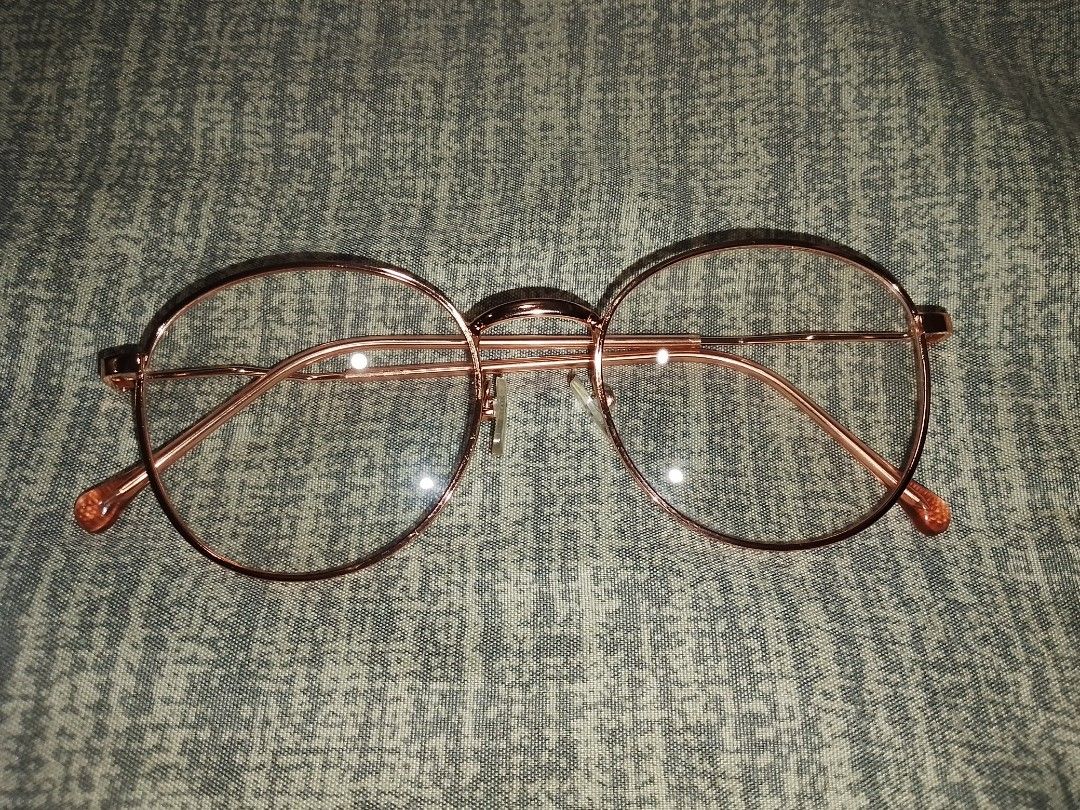Rose Gold Round Frame Eyeglasses (Category: Sunglasses & Eyewear) located in Manila. Submitted by anayaella (Listing ID 1459226520, Image 1). Description: - Round eyeglasses with a chic rose gold frame. - Clear, versatile lenses suitable for everyday use. - Simple and classic design, perfect as a fashion accessory. - Lightweight frame ensures all-day comfort. - Includes adjustable nose pads for a personalized fit..