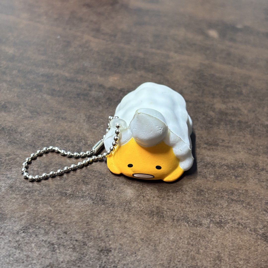 Sanrio Gudetama Squishy Charm Keychain (Category: Character Goods) located in Manila. Submitted by nero.ph (Listing ID 1459135839, Image 1). Description: - Cute Gudetama squishy charm - Features a ball chain for easy attachment - Officially from Sanrio, featuring the lazy egg character - Made in China - Ideal for decorating bags, backpacks, or keys - Small and portable design.
