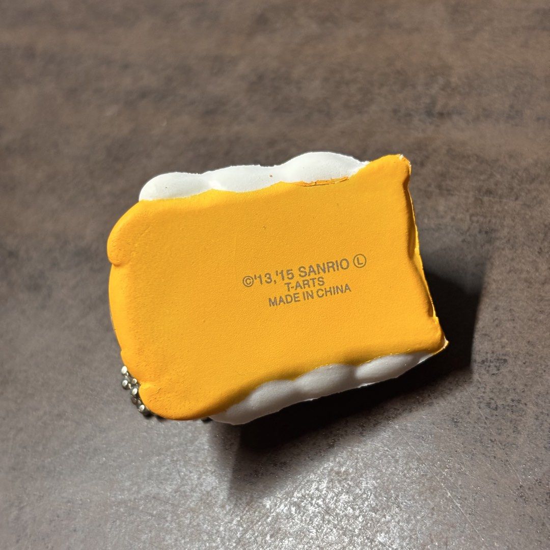 Sanrio Gudetama Squishy Charm Keychain (Category: Character Goods) located in Manila. Submitted by nero.ph (Listing ID 1459135839, Image 2). Description: - Cute Gudetama squishy charm - Features a ball chain for easy attachment - Officially from Sanrio, featuring the lazy egg character - Made in China - Ideal for decorating bags, backpacks, or keys - Small and portable design.