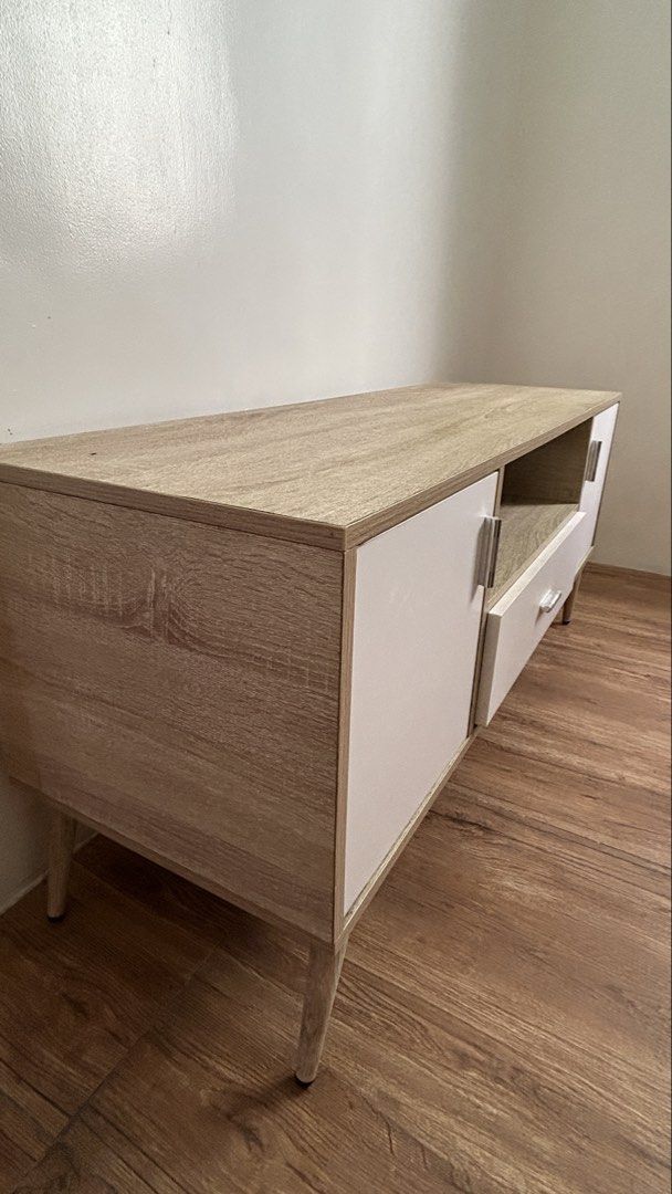 San-Yang TV Console Table (Category: TV Consoles) located in Quezon City. Submitted by jaja.20 (Listing ID 1459142157, Image 3). Description: Brand: San-Yang Furniture Color: Oak and White Size: 120 x 40 x 54 cm (LWH) TV Stand with 2 Cabinets and 1 Drawer Orig price: 5k (please check last photo for reference).