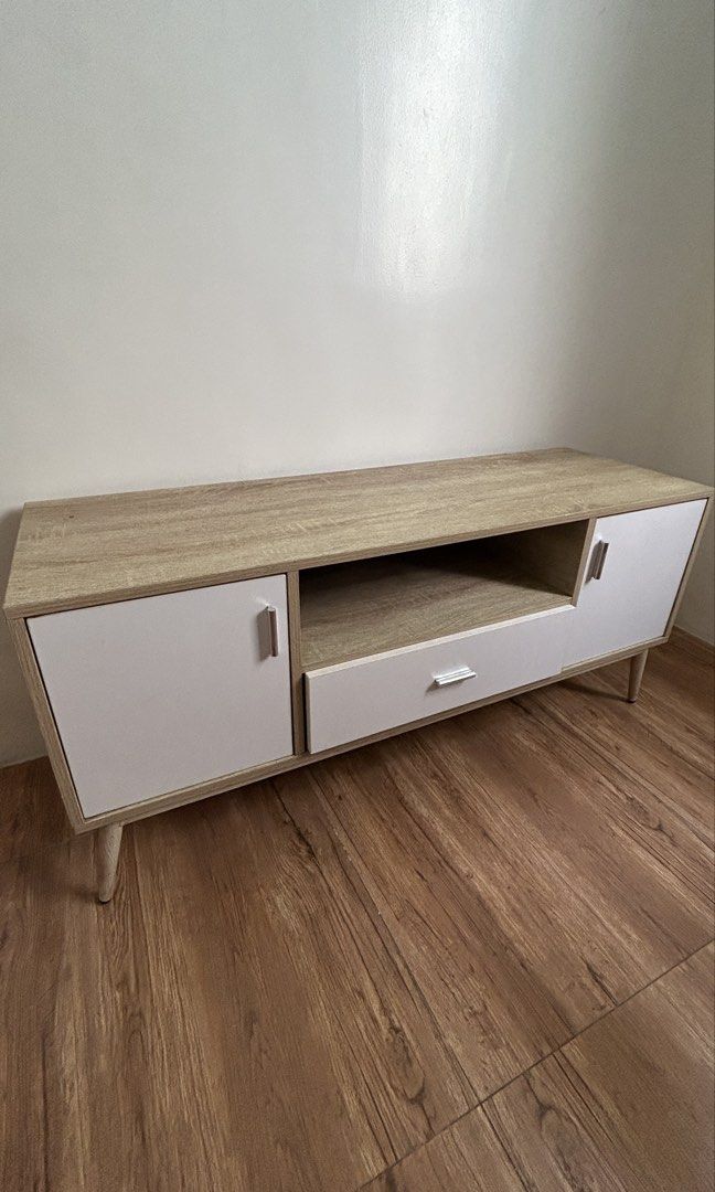 San-Yang TV Console Table (Category: TV Consoles) located in Quezon City. Submitted by jaja.20 (Listing ID 1459142157, Image 1). Description: Brand: San-Yang Furniture Color: Oak and White Size: 120 x 40 x 54 cm (LWH) TV Stand with 2 Cabinets and 1 Drawer Orig price: 5k (please check last photo for reference).