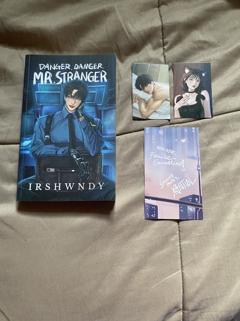 SIGNED Danger, Danger Mr. Stranger by Irshwndy - Signed (Category: Storybooks) located in Caloocan City. Submitted by lienzonius (Listing ID 1459114424, Image 1). Description: - Book Title: Danger, Danger Mr. Stranger - Author: Irshwndy - Special Features: Includes cyber inserts and a signed page - Condition: Good - Extras: Comes with two character art cards - Ideal for: Fans of the author.
