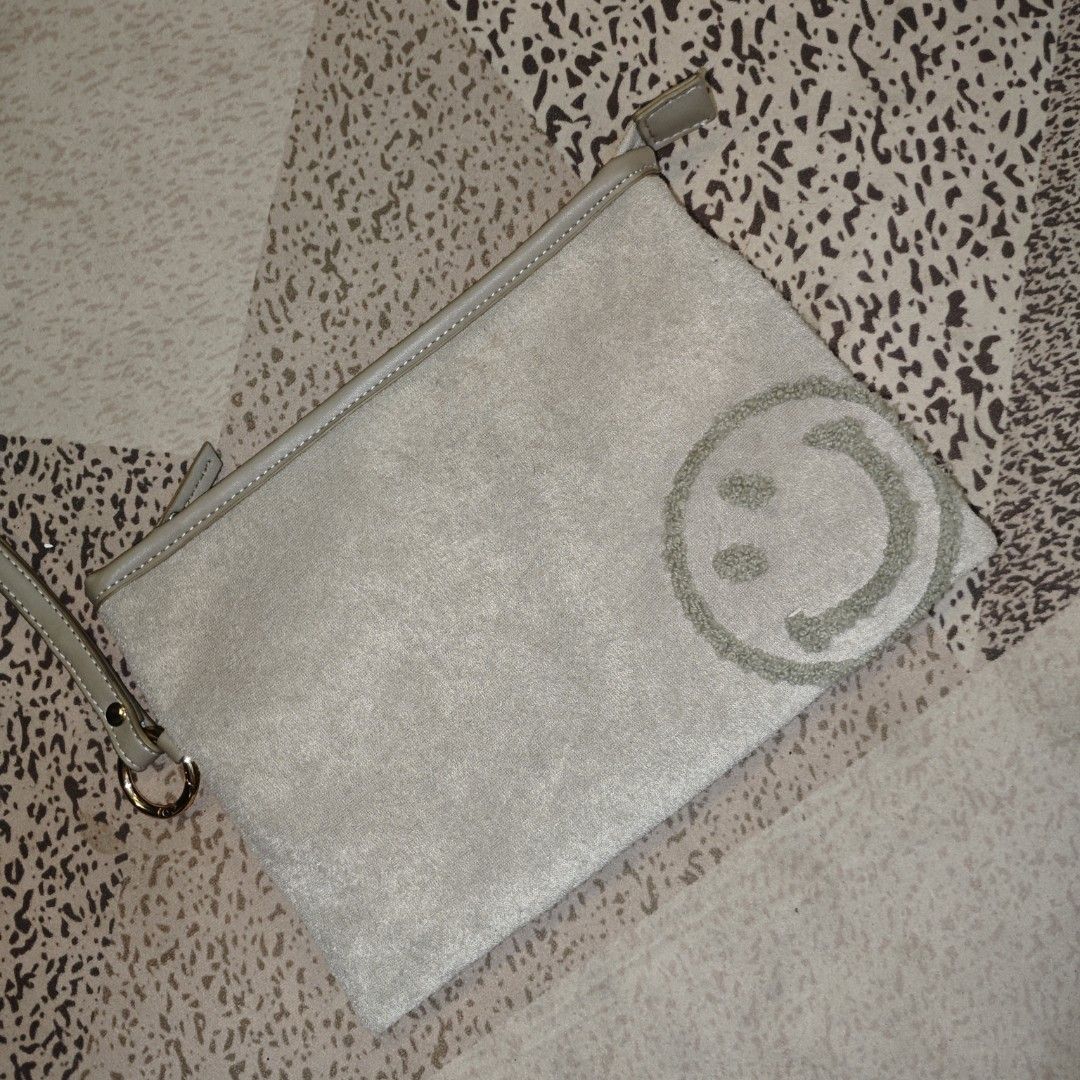 Smiley X Cooco Gray Clutch Bag (Category: Clutches) located in Tanay. Submitted by polothriftedit (Listing ID 1459123787, Image 2). Description: No issue Excellent condition No loose stitches, no distressing no return, no exchange, no refund [ pwede tumawad kahit walang kasalanan ].