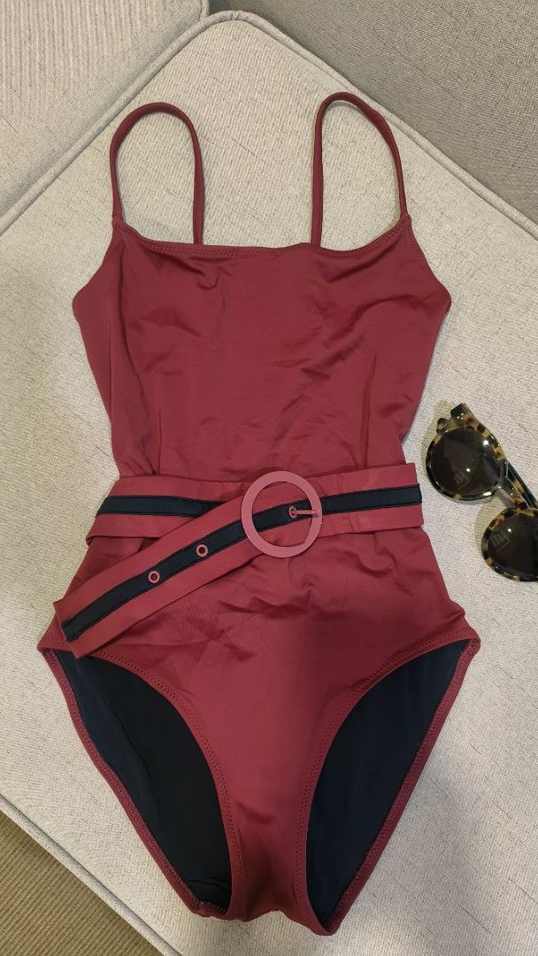 Solid & Striped One Piece Swimsuit with Belt (Category: Bikinis & Swimsuits) located in Makati City. Submitted by fashion_thrift_ (Listing ID 1459288870, Image 1). Description: Maroon one-piece swimsuit from Solid & Striped. Comes with a matching belt that has a circular buckle. The belt has black stripes and button details. Straps are thin spaghetti straps. Back is a racerback style. Great for the beach or pool..