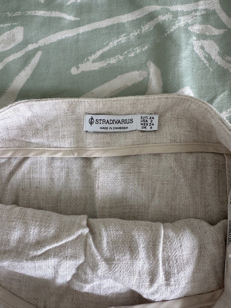 Stradivarius Linen Blend Wrap Midi Skirt (Category: Skirts) located in Paranaque City. Submitted by declutterwyae (Listing ID 1459137897, Image 3). Description: Lightweight midi skirt from Stradivarius. Natural linen blend fabric. Features a wrap-style front with a decorative buckle detail at the waist. High-waisted design. Perfect for casual or dressed-up occasions. Easy to style for summer..