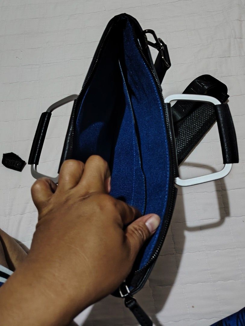 TANTIN Black Laptop Bag with Shoulder Strap (Category: Laptop Bags & Sleeves) located in Davao. Submitted by dareyl_121422 (Listing ID 1459142234, Image 3). Description: - Sleek black TANTIN laptop bag - Elegant silver handles - Detachable shoulder strap for versatile carrying - Bright blue interior lining with convenient pockets - Smooth, reliable zippers - Brand name clearly visible on hardware and strap - Ideal for work, school, or travel.