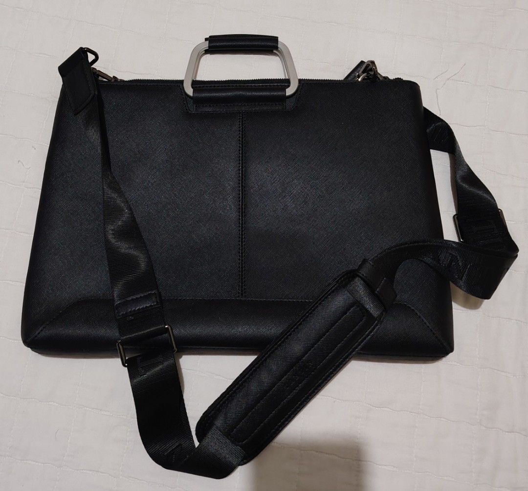 TANTIN Black Laptop Bag with Shoulder Strap (Category: Laptop Bags & Sleeves) located in Davao. Submitted by dareyl_121422 (Listing ID 1459142234, Image 2). Description: - Sleek black TANTIN laptop bag - Elegant silver handles - Detachable shoulder strap for versatile carrying - Bright blue interior lining with convenient pockets - Smooth, reliable zippers - Brand name clearly visible on hardware and strap - Ideal for work, school, or travel.
