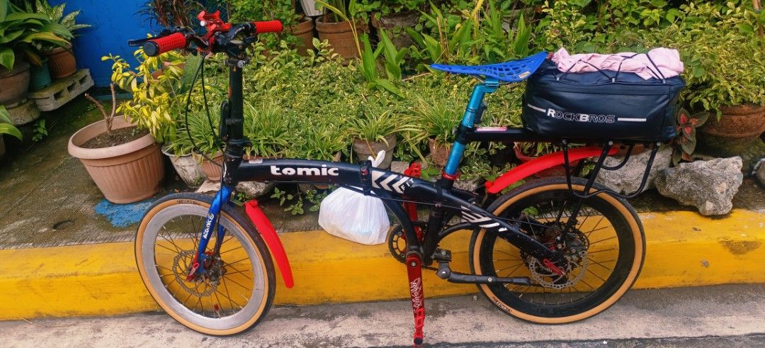 Tomic Folding Bike with Rockbros Bag (Category: Bicycles) located in Caloocan City. Submitted by clarocoraz12465 (Listing ID 1459200968, Image 3). Description: - Tomic folding bike - Black frame with red and blue accents - Comes with a Rockbros rear bag - Disc brakes on both wheels - Ready for your next ride - Ideal for commuting or casual cycling.