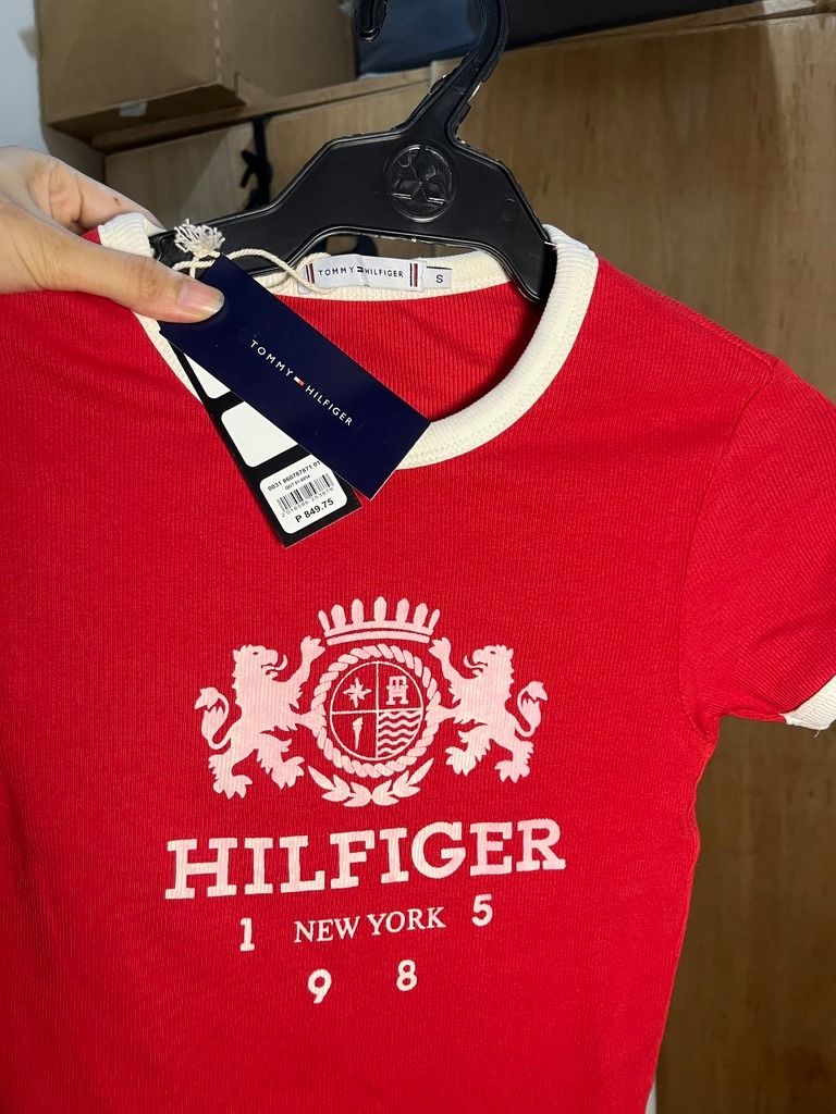 Tommy Hilfiger White & Red Crop Top (Category: Others Tops) located in Angeles City. Submitted by ownit_ac (Listing ID 1459200196, Image 3). Description: Already laundered & ready to wear Ribbed & semi-stretchy material Tag still intact P849.75 on tag Size: XS to S Brand: Tommy Hilfiger Unnoticeable flaw: Sewn, can be seen on the 4th picture .