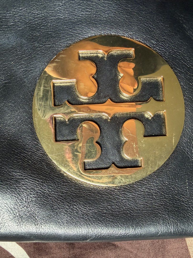 Tory Burch Black Leather Shoulder Kili Bag (Category: Luxury Bags & Wallets) located in Digos. Submitted by m__rth4 (Listing ID 1459112134, Image 3). Description: - Authentic Tory Burch black leather bag - Features gold chain strap and hardware - Versatile: can be worn as a shoulder bag or a clutch - Interior includes zip pockets - Minor signs of wear on exterior leather and hardware, consistent with normal use - Interior is clean and well-mainta