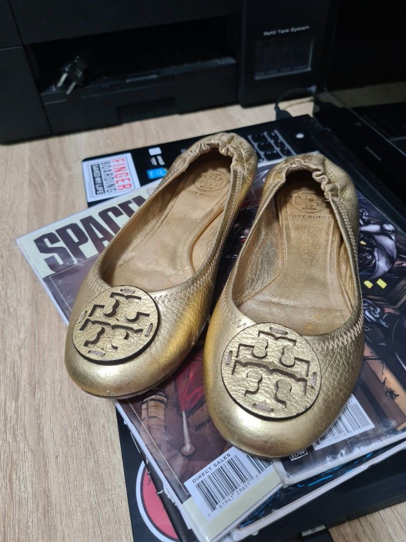 Tory Burch Gold Ballet Flats (Category: Flats & Sandals) located in Manila. Submitted by sevyaleinad (Listing ID 1459225692, Image 1). Description: - Gold Tory Burch ballet flats - Classic design with signature Tory Burch logo - Comfortable slip-on style - Perfect for everyday wear or elevating any outfit.