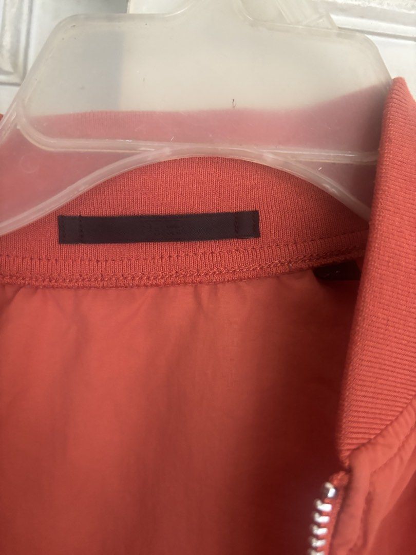 Uniqlo Orange Bomber Jacket (Category: Coats, Jackets and Outerwear) located in Cainta. Submitted by doverparfum (Listing ID 1459107066, Image 2). Description: - Orange bomber jacket - Zip-up front with pockets - Ribbed cuffs and hem - Lightweight material - Great for layering - Easy to style.
