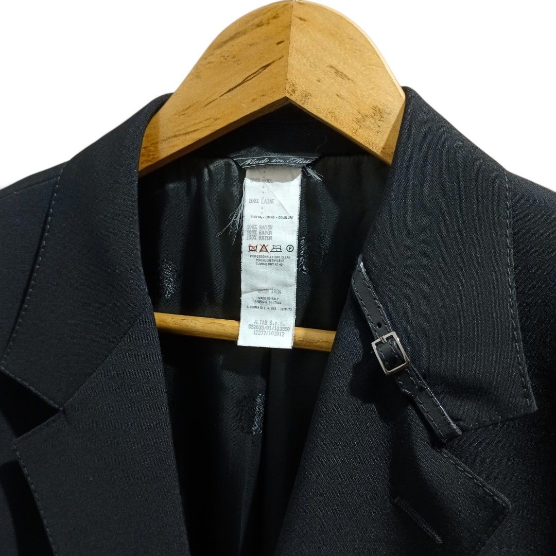 Versace Black Wool Blazer with Buckle Details (Black) (Category: Coats, Jackets and Outerwear) located in Manila. Submitted by mf.classics (Listing ID 1459137498, Image 3). Description: Versace black wool blazer with unique buckle details. Two-button closure, cuff buttons, and full lining. Versatile for any occasion. Measurements: 31 L 22 W Issues: N/A Condition: 10/10.