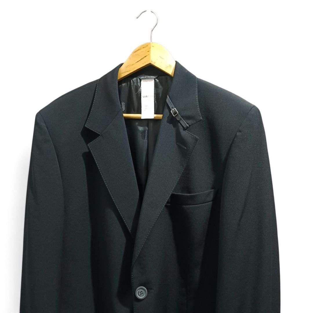 Versace Black Wool Blazer with Buckle Details (Black) (Category: Coats, Jackets and Outerwear) located in Manila. Submitted by mf.classics (Listing ID 1459137498, Image 2). Description: Versace black wool blazer with unique buckle details. Two-button closure, cuff buttons, and full lining. Versatile for any occasion. Measurements: 31 L 22 W Issues: N/A Condition: 10/10.