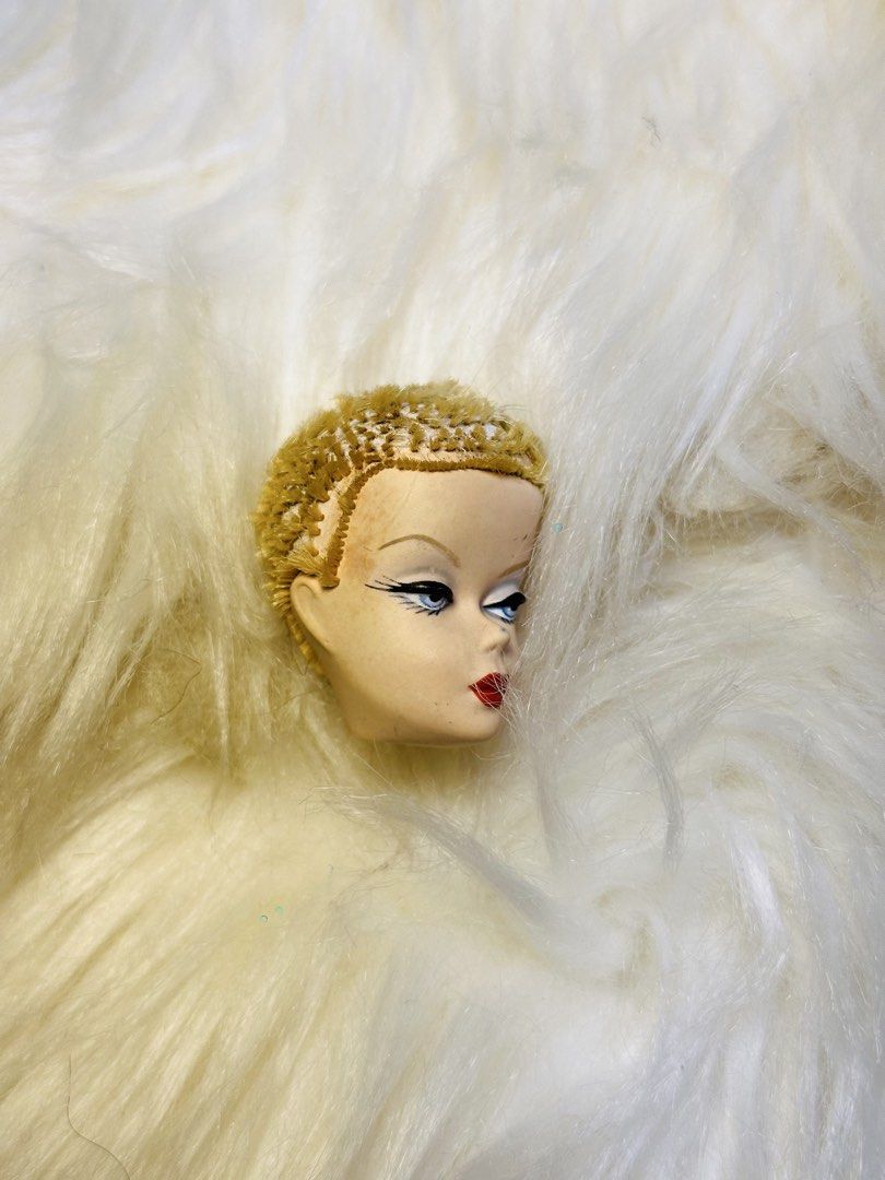 Vintage Mattel 1958 Doll Head (Category: Kids Toys) located in Santa Maria. Submitted by houseofluckytoystore (Listing ID 1459092061, Image 2). Description: - Vintage Mattel doll head - Dated 1958 - Blonde, styled hair - Blue eyes with detailed makeup (eyeliner, lashes) - Red lips with beauty mark - Ideal for collectors, display, or replacement parts barbie silkstone Pre-Loved toys and signs of usage Issue there hole on the head what you see is w