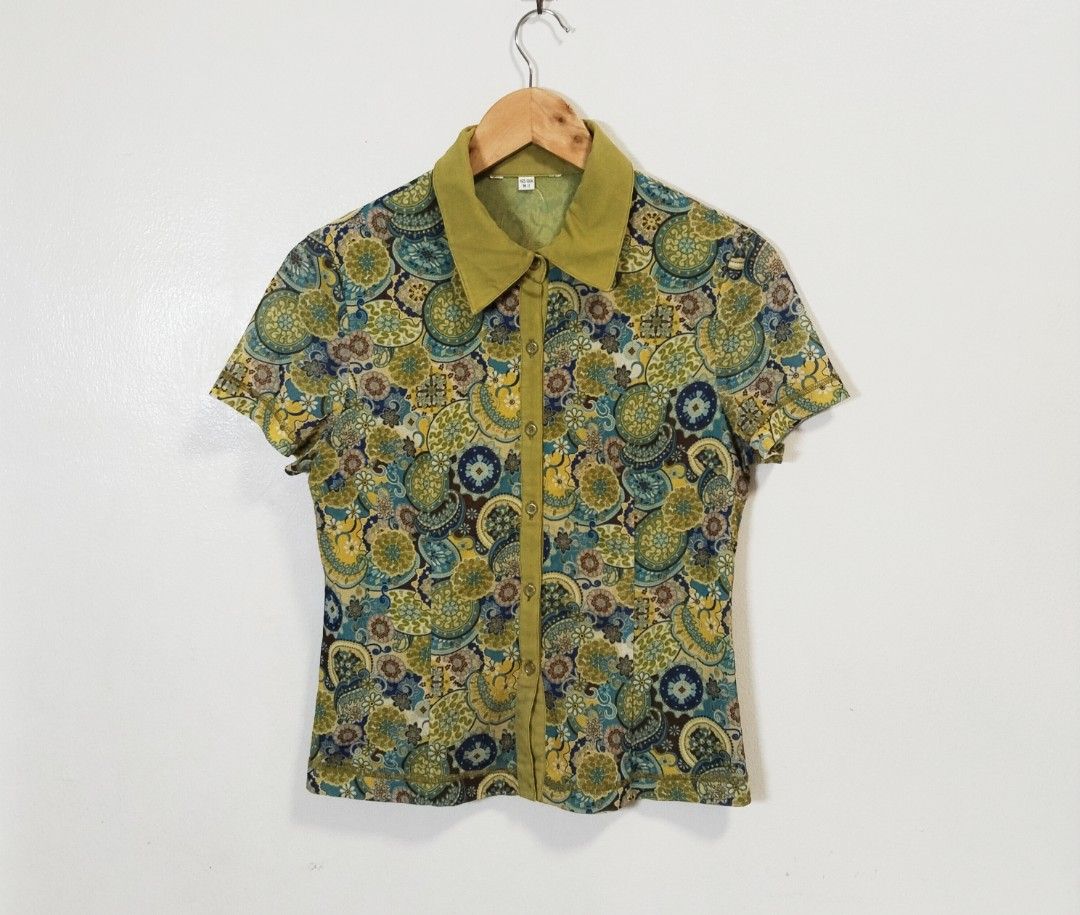 Vintage Print Button-Up Shirt (Category: Blouses) located in Pateros City. Submitted by blashjunks.y2k (Listing ID 1459188677, Image 2). Description: - Vibrant psychedelic print short-sleeved button-up shirt - Classic collar and button-down front - Features circular motifs in yellow, blue, green, and brown - Estimated size: Medium (M) - Perfect for a retro-inspired outfit.