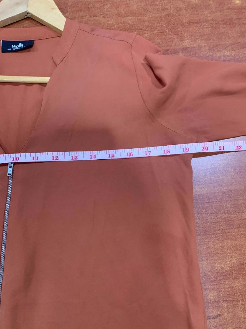 Wallis Orange Long Sleeve Zip Front Blouse (Category: Blouses) located in Paranaque City. Submitted by rizatamayo (Listing ID 1459231130, Image 3). Description: - Orange long sleeve blouse from Wallis - Features a zip front detail - Lightweight fabric, perfect for dressing up or down - Approximate chest measurement: 18 inches - Approximate sleeve length: 23 inches - Button detail on cuffs.