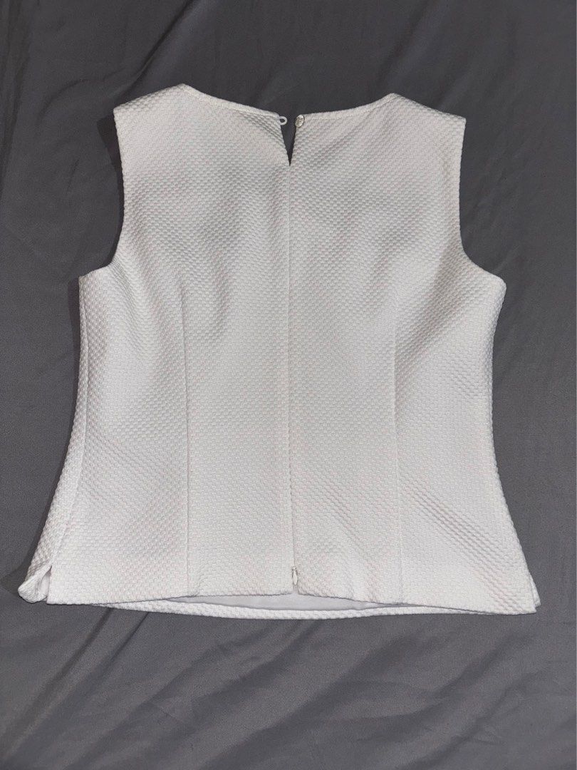White Blouse for women (Category: Blouses) located in Manila. Submitted by alieamarie (Listing ID 1459195152, Image 2). Description: This white textured sleeveless top , a classic crew neckline trimmed with dark blue stitching and a vertical waist panel with gold and blue geometric embellishments..