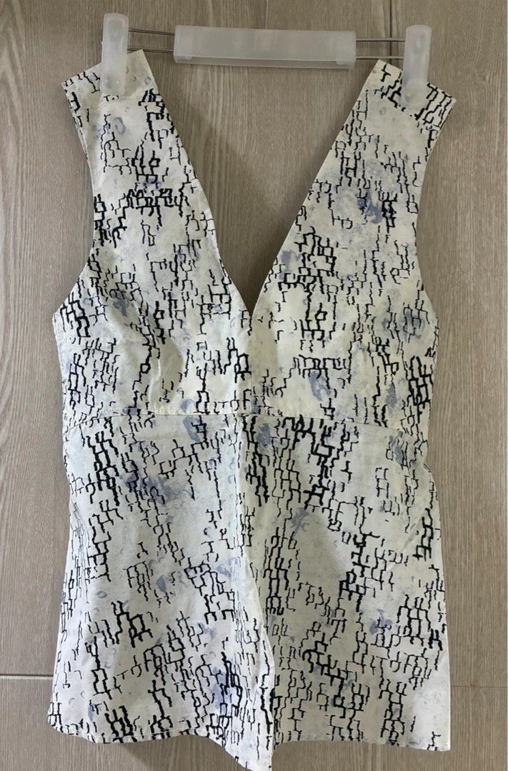 White Sleeveless V-Neck Top with Abstract Print (Category: Sleeveless) located in Manila. Submitted by decluterthings888 (Listing ID 1459102247, Image 2). Description: - Sleeveless white top with a deep V-neckline. - Features a unique black and blue abstract print. - Fabric has a subtle, elegant sheen. - Flattering cut that flares slightly at the hem. - Versatile piece: dress it up or down!.