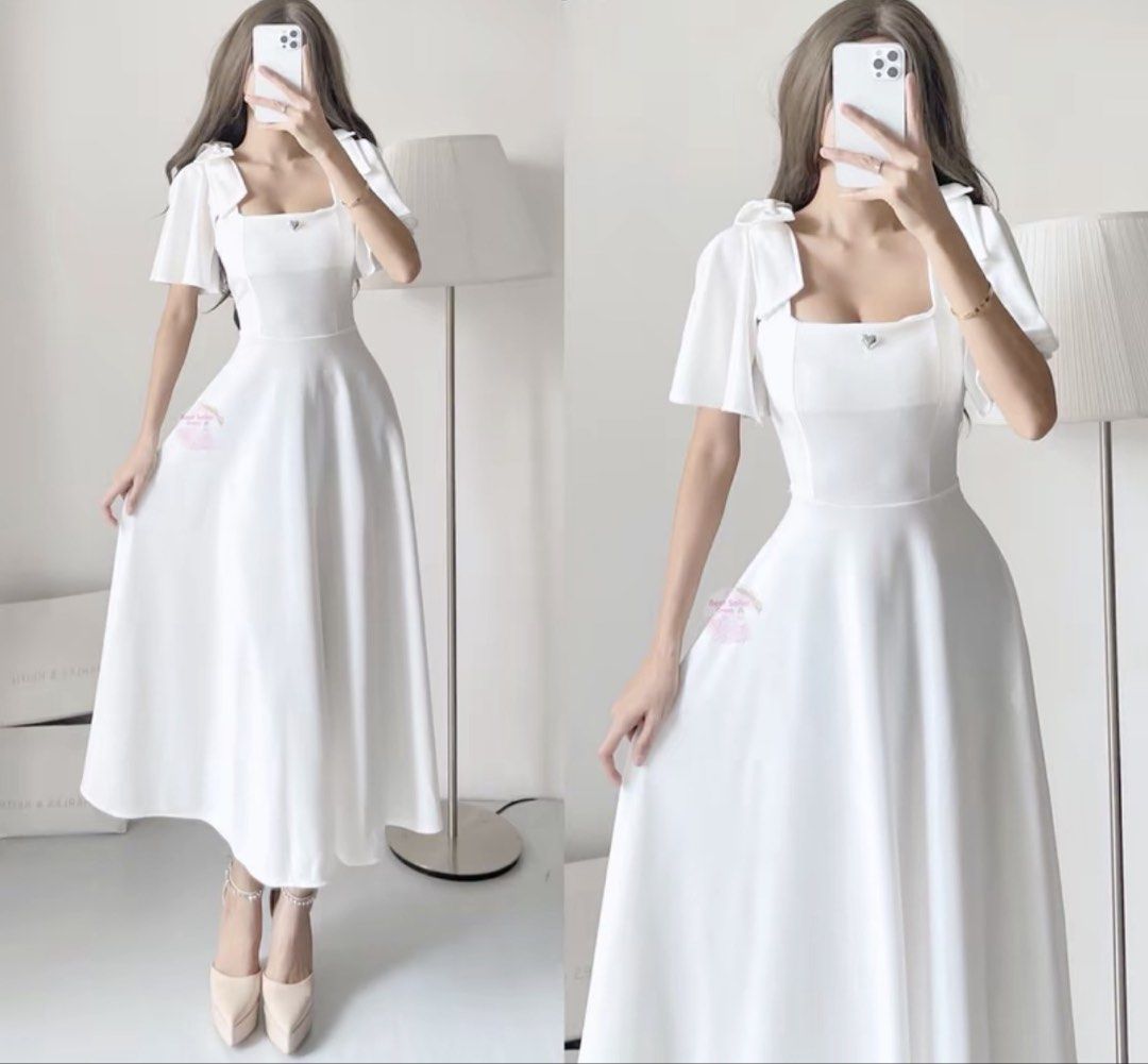White Square Neck Puff Sleeve Midi Dress (Category: Dresses) located in Manila. Submitted by cosmicocean.3de8c6 (Listing ID 1459211990, Image 1). Description: - White midi dress - Square neckline - Puff sleeves - Heart detail on chest - Flowy mid-calf skirt - Versatile for events or casual chic - Comfortable and stylish.