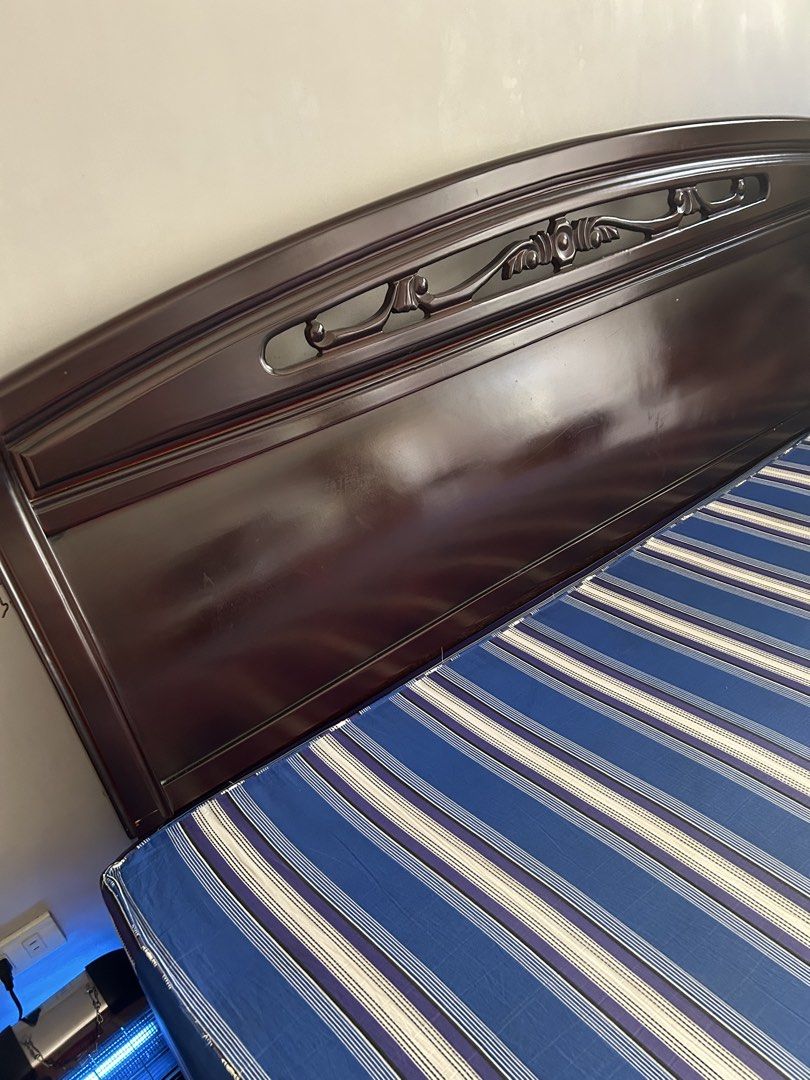 Wood king Bed Frame with uratex mattress (Category: Bed Frames & Mattresses) located in Manila. Submitted by studiogrl (Listing ID 1459179638, Image 3). Description: - Dark wood queen bed frame - Curved headboard with decorative carvings - Blue, white, and purple striped mattress included - Minor wear on bed frame corners - Selling as a complete - uratex mattress included Dismantle n shipping c/o buyer Pickup area near SM Sta mesa.
