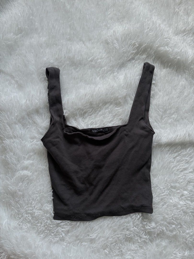 Zara Ribbed Square Neck Tank Top (Category: Sleeveless) located in Batangas. Submitted by m4y4rchiv3s (Listing ID 1459203958, Image 1). Description: - Grey ribbed tank top from Zara - Features a square neckline and thick straps - Made with stretchy material for ultimate comfort - Cropped length, ideal for versatile styling - Great for layering or wearing on its own.