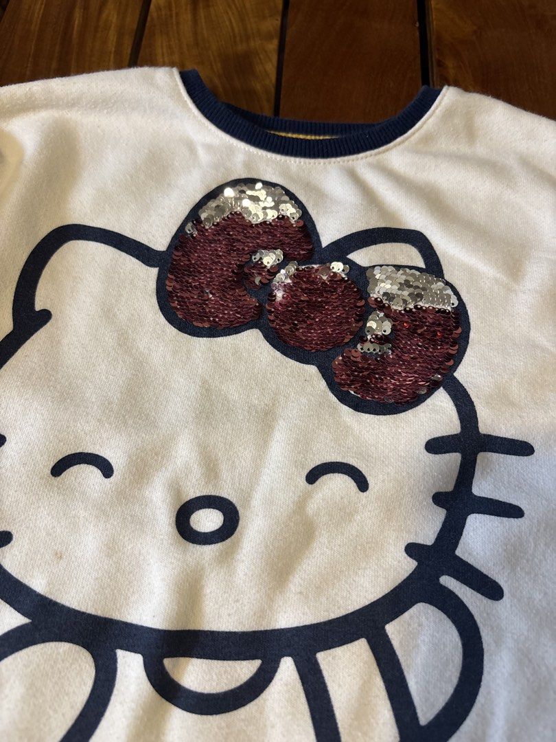 365 Kids Hello Kitty Sequin Bow Sweatshirt Rainbow Sleeve (Category: Babies & Kids Fashion) located in Manila. Submitted by wardrobeinmnl (Listing ID 1462943320, Image 2). Description: SIZE: 5 -White long-sleeve sweatshirt - Large Kitty graphic - Kitty bow with reversible red/silver sequins - Colorful rainbow stripes on sleeves - Ribbed navy blue neckline and cuffs - Made from a comfortable cotton blend - Ideal for Kitty fans.