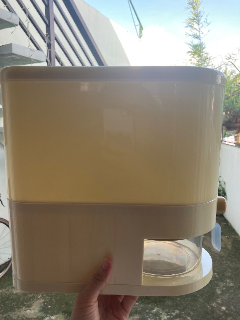 5 kg Automatic Press Type Rice Dispenser (Category: Pitchers & Dispensers) located in Manila. Submitted by ehemcoughnut (Listing ID 1462968755, Image 3). Description: - Milky white-colored rice dispenser - 5 kg capacity - Includes measuring cup with water drain - Built-in insect repellent box - Non-stick funnel design - 297 pesos from orange app RFS: decluttering.