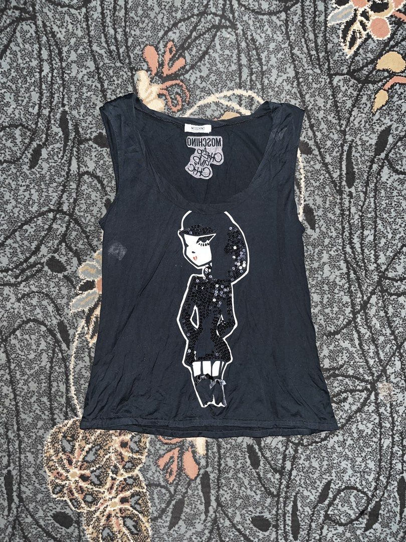 90’s MOSCHINO Cheap&Chic Sequin Top (Category: Others Tops) located in Manila. Submitted by kashjulliane (Listing ID 1462973107, Image 1). Description: This is an archival Moschino Cheap and Chic black tank top. It features a large graphic illustration of a stylized doll-like woman detailed with shimmering black sequin embellishments across her hair, dress, and boots. The interior neck area features the signature upside-down and mirrored “Cheap a