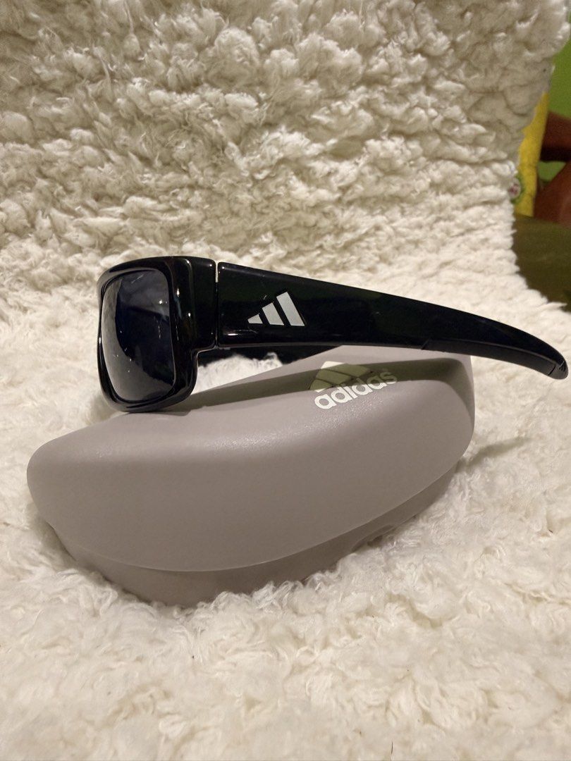 Adidas Kundo A374 00 6050 with Case (Category: Sunglasses & Eyewear) located in Carmona. Submitted by ccdlrs (Listing ID 1463099524, Image 2). Description: - Brand: Adidas - Model: Adidas Kundo A374 00 6050 - Frame Color: Glossy Black - Features: White Adidas logo on sides - Includes: Original hard case, drawstring pouch No scratches Rfs: declutter.