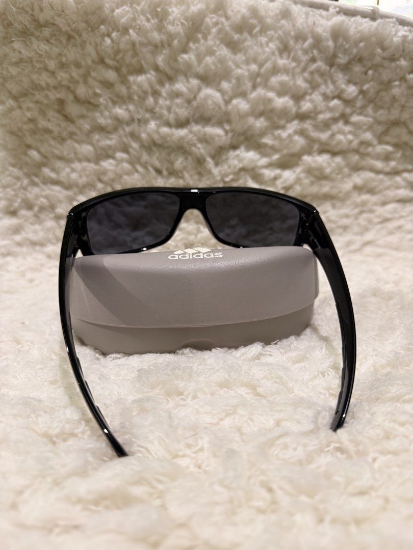 Adidas Kundo A374 00 6050 with Case (Category: Sunglasses & Eyewear) located in Carmona. Submitted by ccdlrs (Listing ID 1463099524, Image 3). Description: - Brand: Adidas - Model: Adidas Kundo A374 00 6050 - Frame Color: Glossy Black - Features: White Adidas logo on sides - Includes: Original hard case, drawstring pouch No scratches Rfs: declutter.