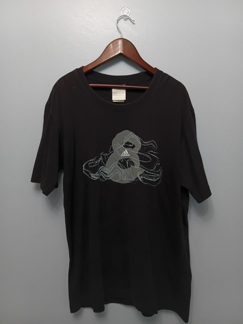 Adidas Graphic T-Shirt (Category: Tshirts & Polo Shirts ) located in Angeles City. Submitted by itsandspreloved (Listing ID 1463026639, Image 1). Description: - Black Adidas t-shirt - Features a cool graphic design on the front - Small Adidas logo on the back hem - Tag indicates Asian Size M - Perfect for everyday casual wear.