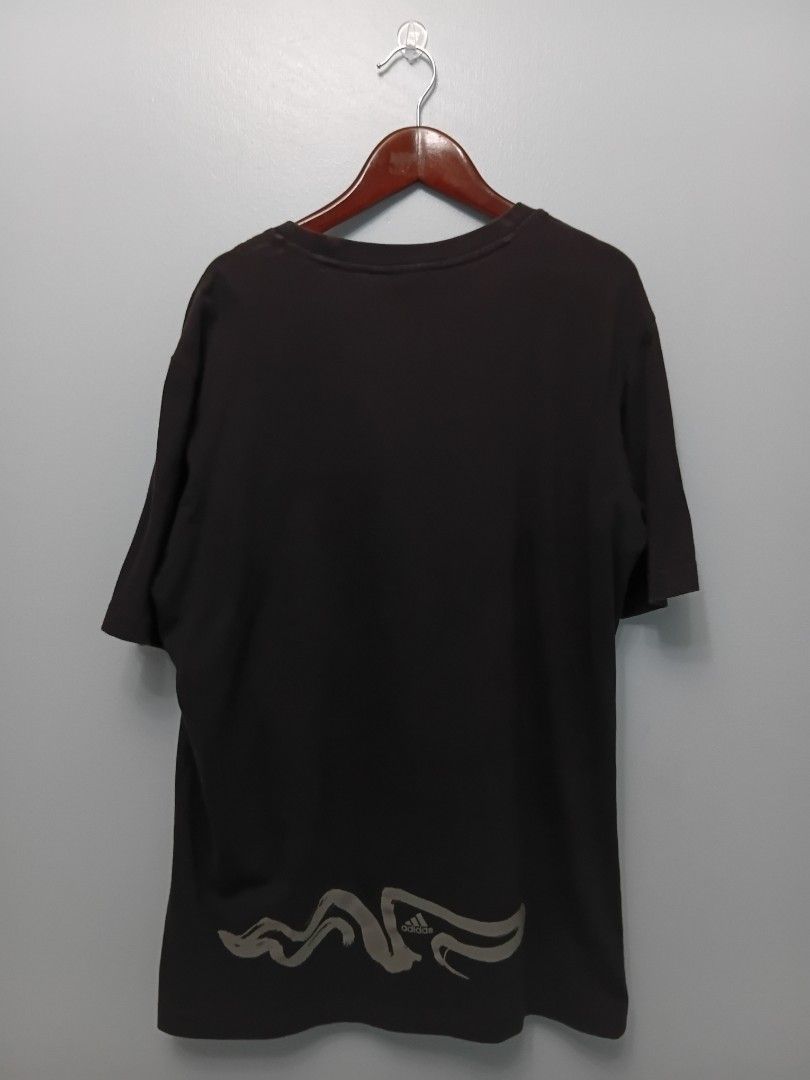 Adidas Graphic T-Shirt (Category: Tshirts & Polo Shirts ) located in Angeles City. Submitted by itsandspreloved (Listing ID 1463026639, Image 2). Description: - Black Adidas t-shirt - Features a cool graphic design on the front - Small Adidas logo on the back hem - Tag indicates Asian Size M - Perfect for everyday casual wear.