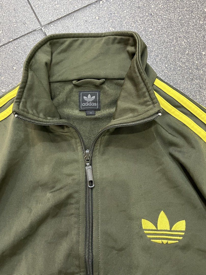 Adidas Track Jacket (Category: Coats, Jackets and Outerwear) located in Pasay City. Submitted by trash_or_treasure.543 (Listing ID 1462939470, Image 3). Description: This is Adidas Track Jacket accented with yellow three stripes details and the classic trefoil logo Authentic Size: medium Dimensions: Width: 19 Length: 24 Sleeve Length: 21 Price negotiable .