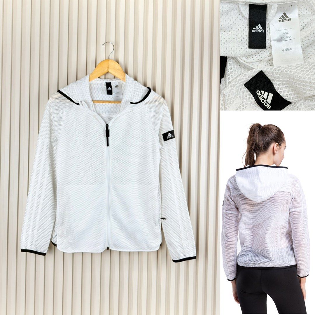 Adidas White Mesh Hooded Jacket A/XL (Category: Coats, Jackets and Outerwear) located in Pasig City. Submitted by trendapparelph (Listing ID 1463033595, Image 1). Description: - White Adidas jacket - Mesh design - Full zip front with hood - Black trim on hood and cuffs - Adidas logo on sleeve and tag - Size: A/XL fits small to medium - Ideal for workouts or casual wear.