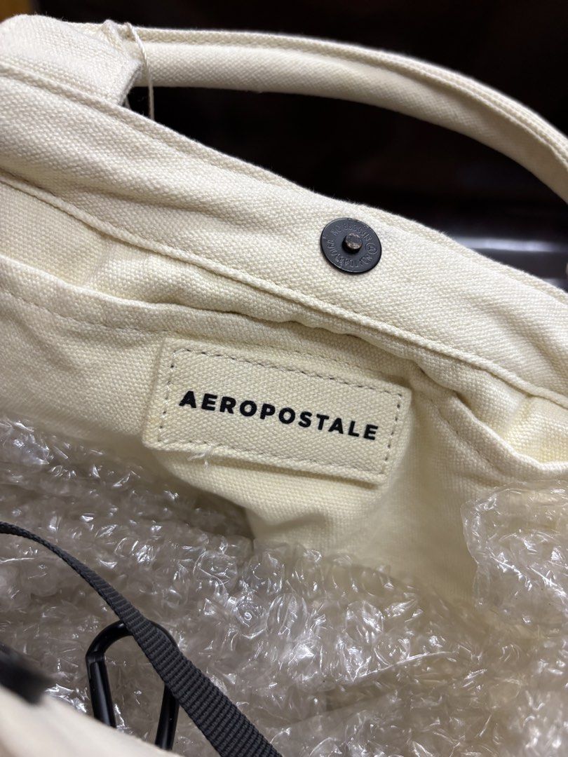 Aeropostale Canvas Tote Bag (Category: Tote Bags) located in Manila. Submitted by robbyrabbit (Listing ID 1462916615, Image 3). Description: - Cream colored canvas tote bag from Aeropostale - Snap closure for secure access - Multiple exterior pockets for quick storage - Interior zippered pocket and slip pocket for organization - Spacious and ideal for everyday use.