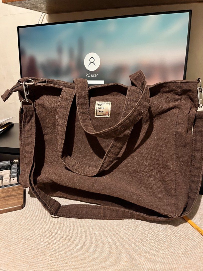 Aestotetics Mini Laptop Sling Bag (Espresso) (Category: Tote Bags) located in Binan City. Submitted by deulli (Listing ID 1463050569, Image 1). Description: Aestotetics Brown Canvas Laptop Sling Bag Bought 2023 but used around 5 times? RFS: not using it anymore Negotiable price Features: - thick canvas material - really big (12”x14”x4”) - fits a 15.6in laptop (see pics) - has padded laptop sleeve - water bottle pocket inside - has a small zippere