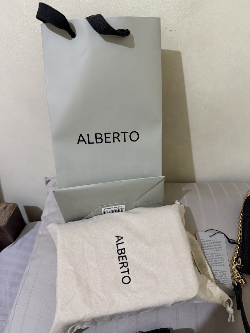 ALBERTO Black Crossbody Bag with Strap (Category: Cross-body Bags) located in Magalang. Submitted by Letsdeclutter_sqs19 (Listing ID 1462967271, Image 3). Description: - Brand: ALBERTO - Type: Crossbody Bag - Color: Black - Material: Textured finish - Hardware: Gold - Features: Adjustable strap - Includes: Dust bag, shopping bag, original tag.
