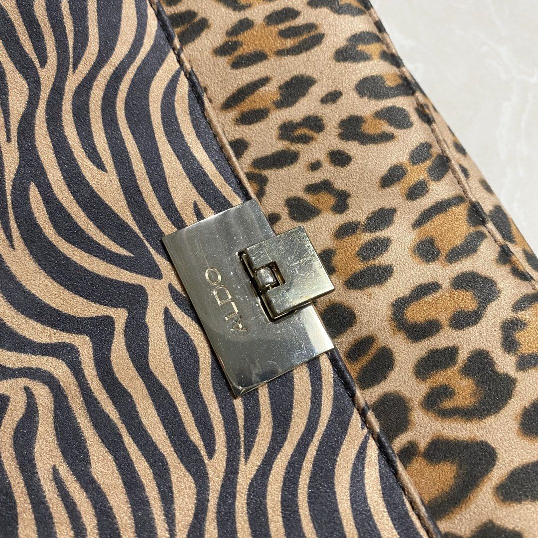ALDO Zebra & Leopard Print Chain Crossbody Bag (Category: Cross-body Bags) located in Muntinlupa City. Submitted by ajdomingo504210 (Listing ID 1462886343, Image 2). Description: - Cute ALDO crossbody bag - Features a mix of zebra and leopard prints - Silver chain strap - Front pocket with ALDO logo - Secure clasp closure - Ideal for nights out or adding flair to your look -No issue .
