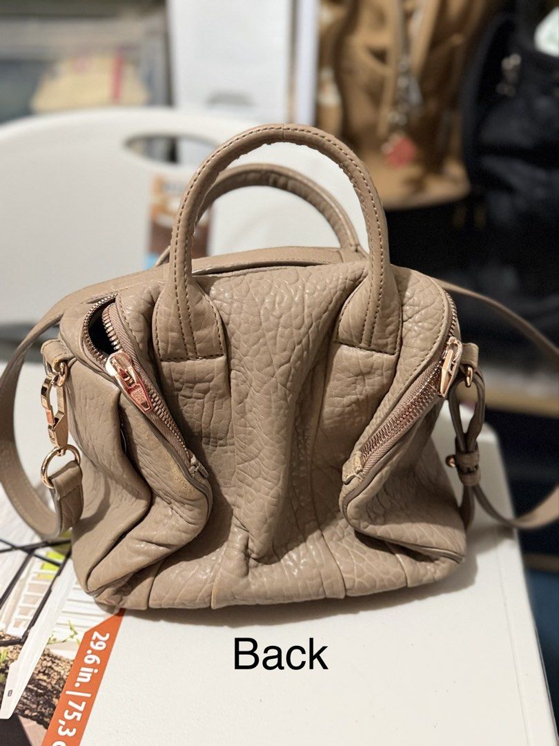 Alexander Wang Rocco Duffel Bag (Category: Luxury Bags & Wallets) located in Quezon City. Submitted by KK_declutterluxx (Listing ID 1463118327, Image 2). Description: - Authentic Alexander Wang Rocco duffel bag - taupe color - Luxurious pebbled leather - Stylish rose gold hardware - Functional interior with zip pocket and compartments - Minor marks on leather trim (please check photos for details) - Complete studs/ no discoloration Rfs: Naliliita