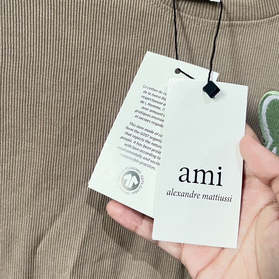 AMI Paris Ribbed T-Shirt (Category: Shirts) located in Quezon City. Submitted by shopnina (Listing ID 1462983405, Image 2). Description: - Brand: AMI Paris - Color: Beige - Style: Ribbed T-shirt - Logo: Signature Ami de Coeur patch on chest - Material: 100% Organic Cotton - Size: Medium (M) - Condition: Brand new with original tags - Perfect for: Casual wear, everyday styling -bought online over…ns RFS: decluttering.