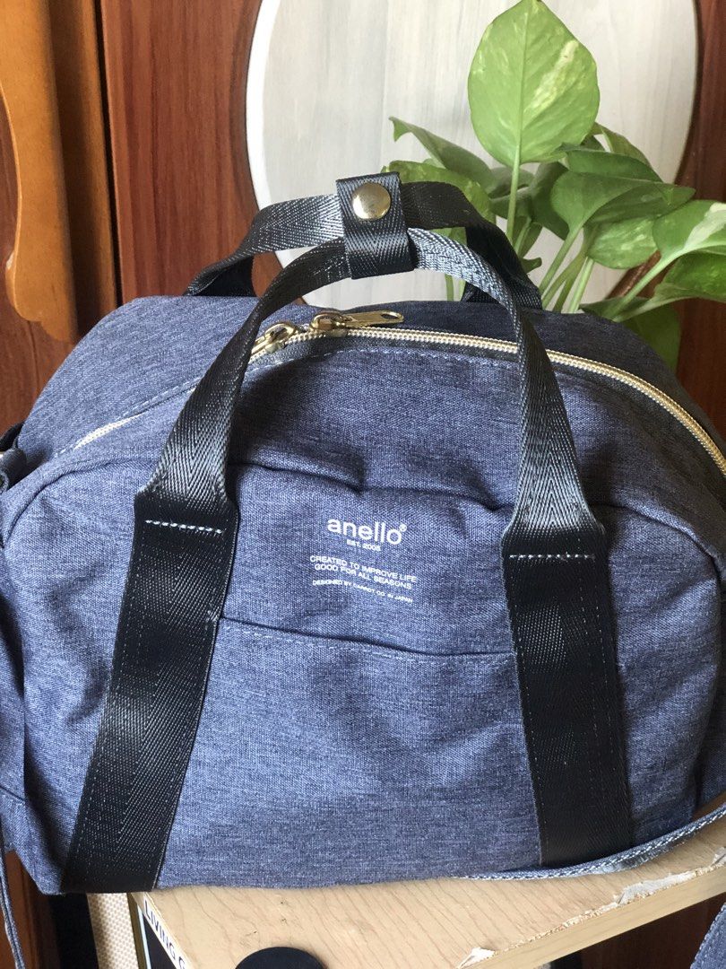 Anello Denim-like Duffle Bag (Category: Cross-body Bags) located in Makati City. Submitted by mitchi_koy28 (Listing ID 1462929443, Image 1). Description: - Anello duffle bag - Dark blue/grey denim-like material - Main zippered compartment - Front zippered pocket - Interior zippered pocket and slip pockets - Top handles with snap closure - Ideal for travel or everyday use.