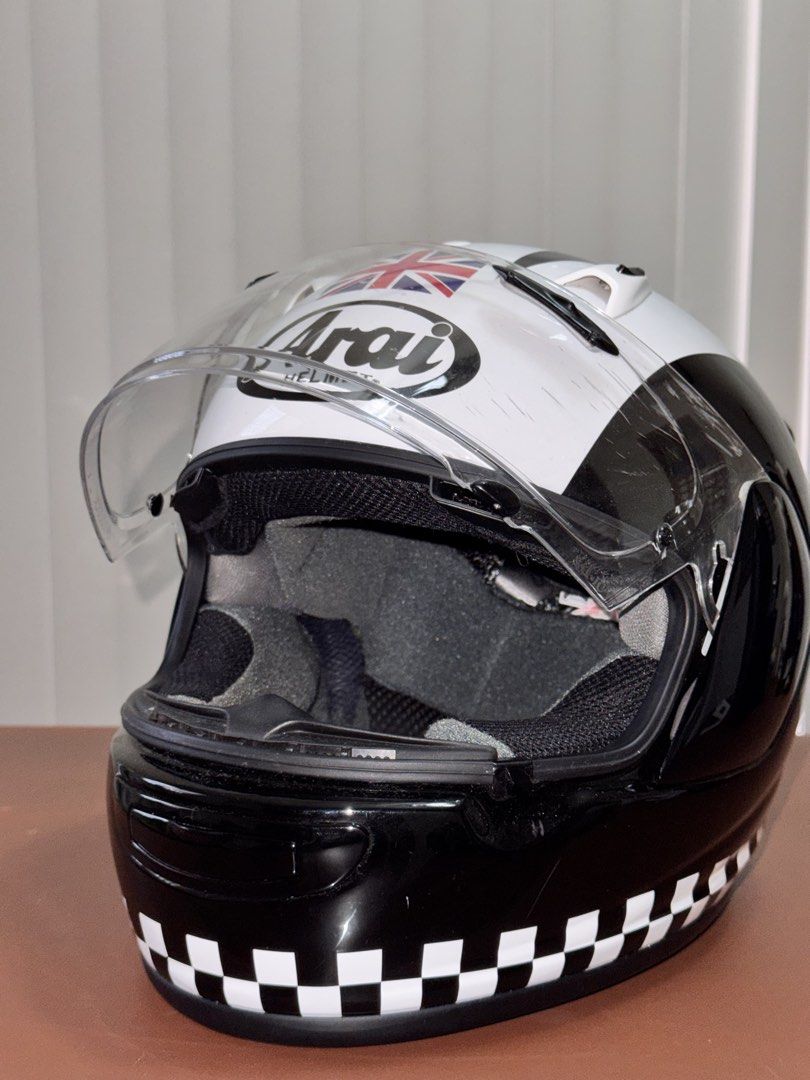Arai Helmet Quantum J (Category: Helmets and other Riding Gears) located in San Pablo. Submitted by declutterjsh (Listing ID 1463037529, Image 2). Description: - Arai full-face helmet - White and black design with iconic Union Jack graphic - Checkerboard pattern on the lower edge - Clear visor included - Some minor scuffs on the outer shell - Interior is clean and well-maintained - Ready for your next adventure on the road.