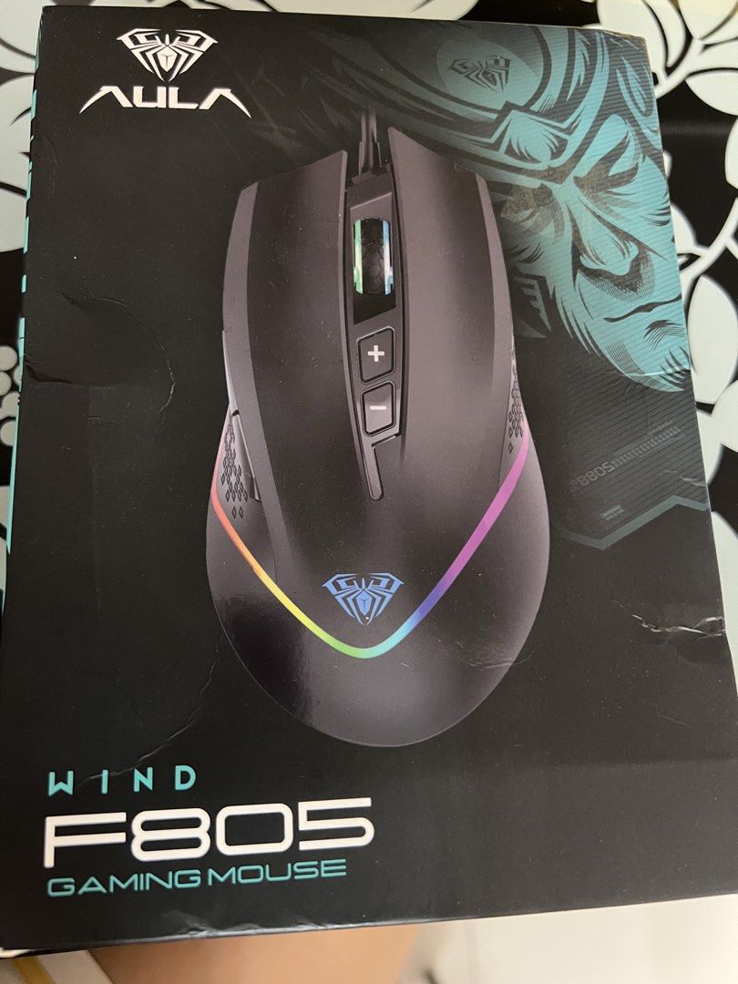 AULA F805 Wind Gaming Mouse (Category: Mouse & Mousepads) located in Manila. Submitted by aevannabrucal (Listing ID 1462926163, Image 1). Description: - AULA F805 Wind Gaming Mouse - Sleek black design with textured grip - Vibrant RGB lighting effects - Adjustable DPI for precision control - Ideal for intense gaming sessions.